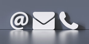 White symbols representing email, a message envelope, and a telephone on a grey background, indicating communication options.