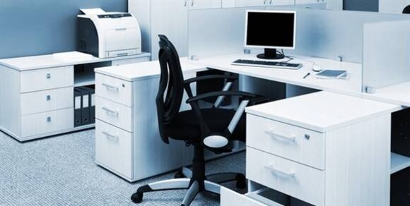 A modern office space featuring a white desk, black chair, computer monitor, and printer in a neat and organised layout.