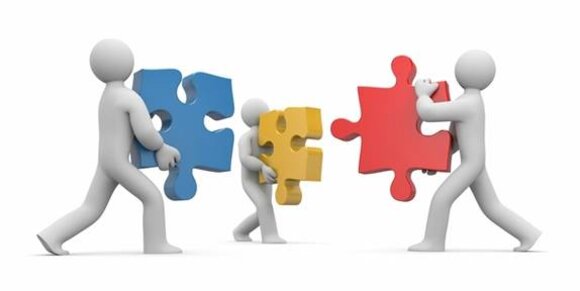 Three abstract figures hold and connect large, colourful puzzle pieces, symbolising teamwork and collaboration.